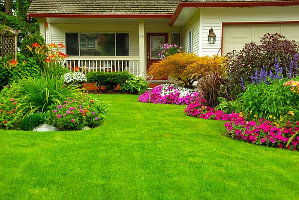 Manicured House and Garden Manicured House and Garden displaying annual and perennial gardens in full bloom. garden house stock pictures, royalty-free photos & images